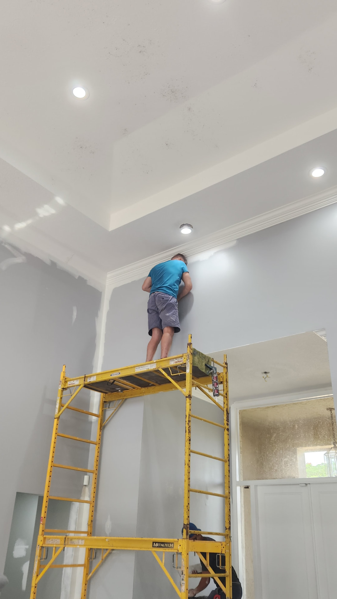 DeSoto painter working on an interior ceiling